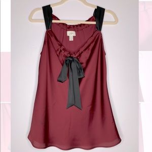 Silk-like blouse, very flattering. Plum/red color with lovely bow in the front.